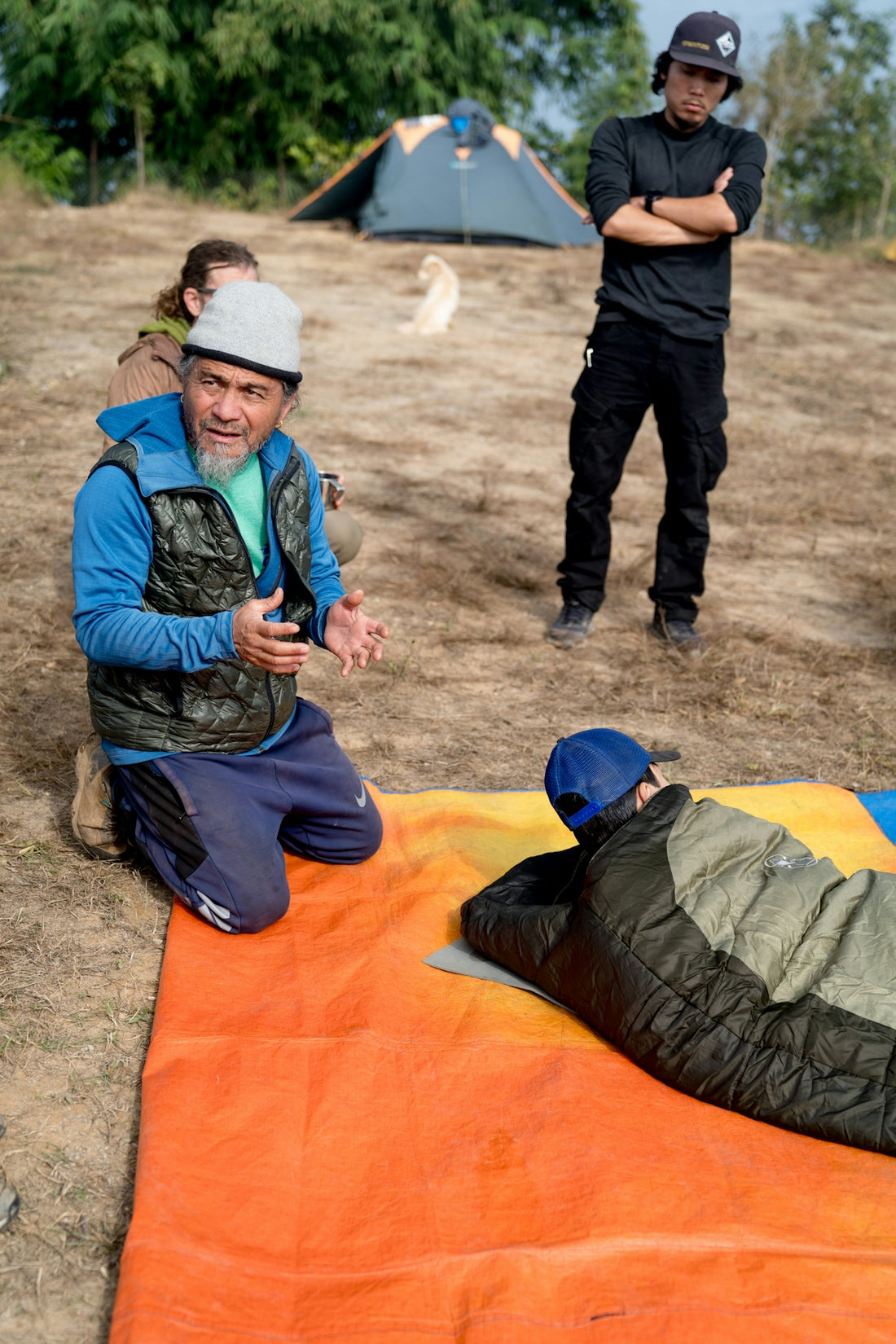 A man laying on top of a sleeping bag